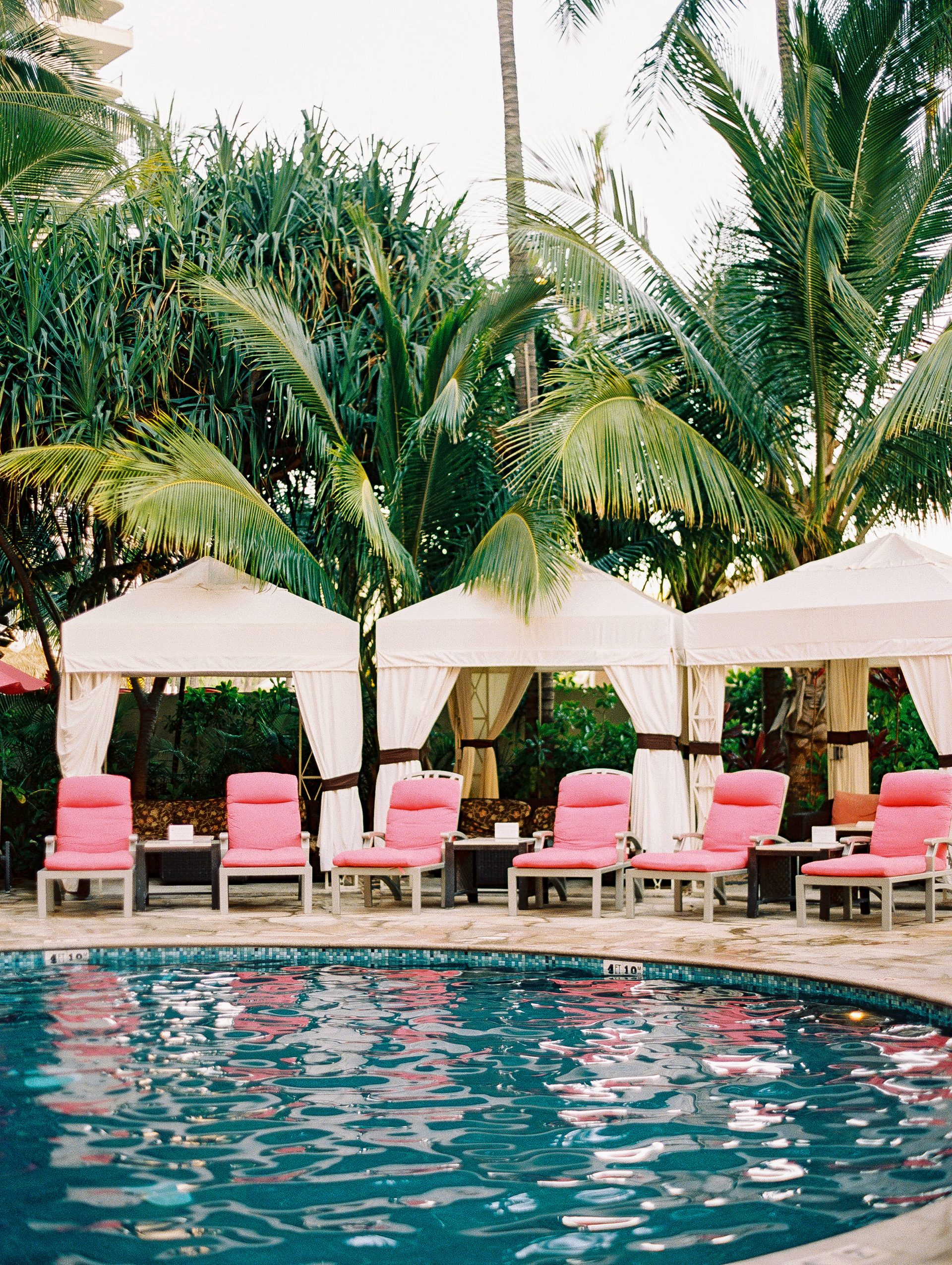 Pink chairs and poolside at a boutique hotel